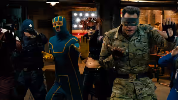 The Motherfucker (Christopher Mintz-Plasse) raising hands among costumed fighters