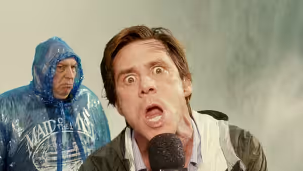 Bruce Nolan (Jim Carrey) speaking into a microphone with wide eyes and open mouth