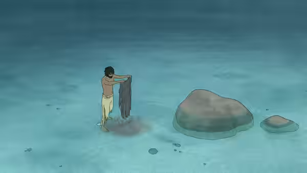 A man holds dark fabric while wading in shallow water near rocks