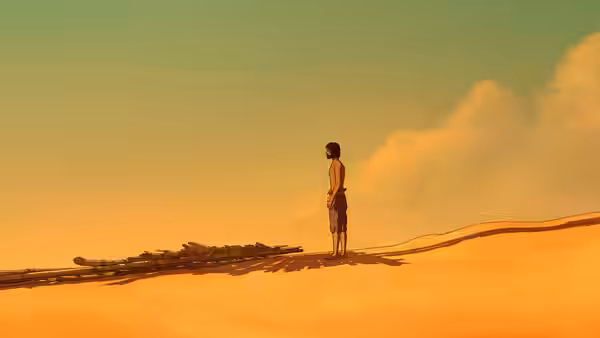 A man stands on a sand dune beside scattered wooden wreckage at sunset
