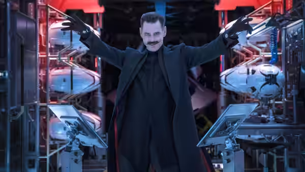Dr. Robotnik (Jim Carrey) with arms outstretched in a laboratory