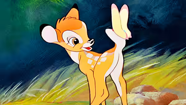 Young Bambi balances on one hind leg in a moonlit grassy clearing
