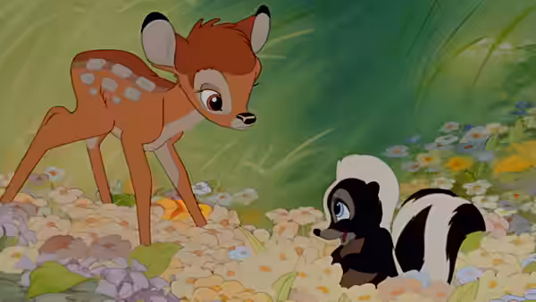 Young Bambi stands facing Flower the skunk in a flower-filled meadow
