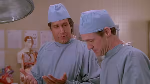 Fletch and another surgeon examine their hands in an operating room