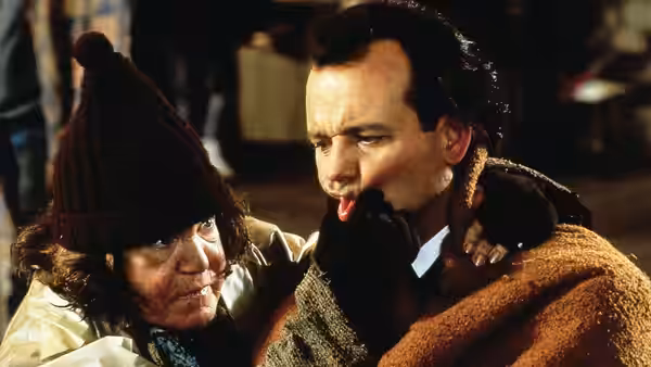 The Ghost of Christmas Past (David Johansen) embraces Francis Cross (Bill Murray) outdoors