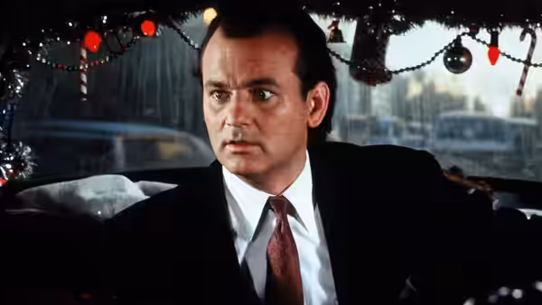 Francis Cross (Bill Murray) sits in a car decorated with Christmas garlands