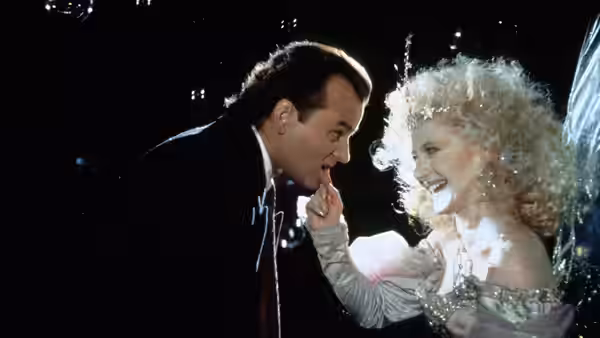 The Ghost of Christmas Present (Carol Kane) smiles and touches Francis Cross (Bill Murray)