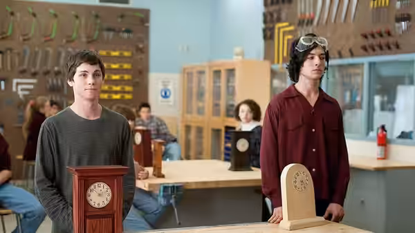 Charlie (Logan Lerman) and Patrick (Ezra Miller) stand in a school workshop