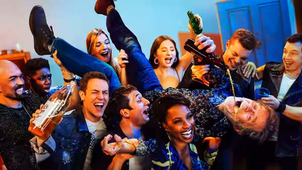 Frank Gallagher (William H. Macy) drinking upside down at a crowded party