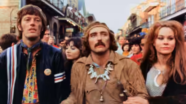 Billy (Dennis Hopper), Wyatt (Peter Fonda) and a red-haired woman walk through a crowded street