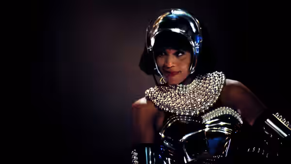 Rachel Marron (Whitney Houston) wearing a metallic costume and helmet