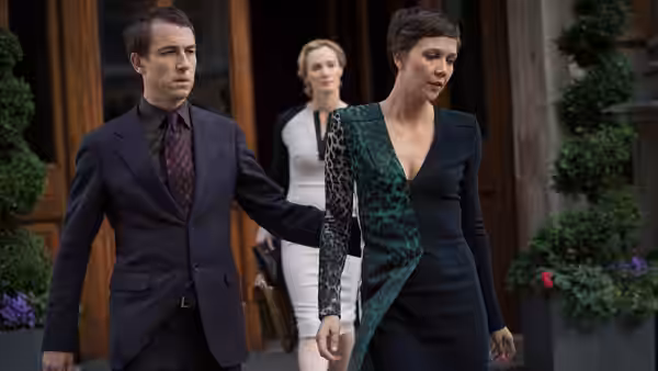 Nessa Stein (Maggie Gyllenhaal) walking beside a man outside a building