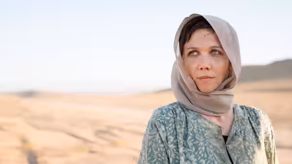 Nessa Stein (Maggie Gyllenhaal) standing in a desert wearing a headscarf