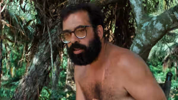 Francis Ford Coppola shirtless with glasses and beard in dense jungle