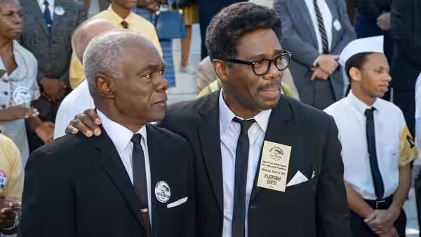 Bayard Rustin (Colman Domingo) stands arm in arm with A. Philip Randolph (Glynn Turman) at a gathering