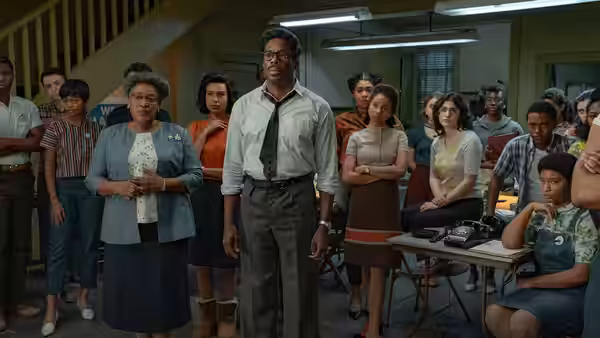 Bayard Rustin (Colman Domingo) stands among organizers gathered in a meeting room