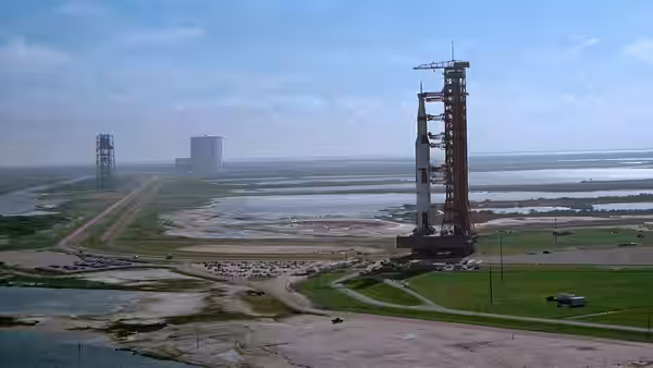 a rocket stands on the launch pad at a coastal space center