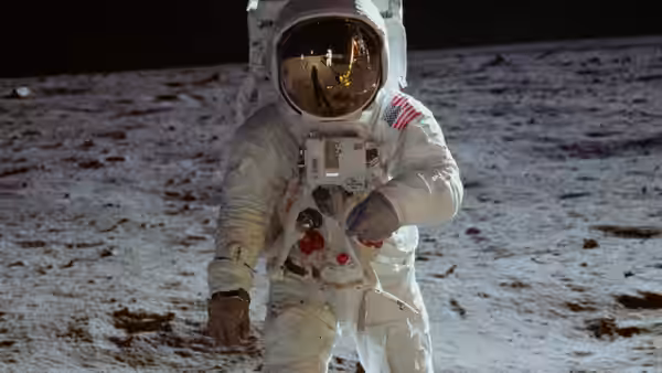 an astronaut in a spacesuit with an American flag patch on the arm
