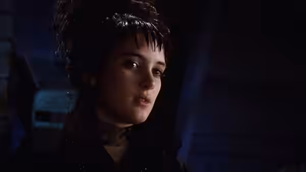 Lydia (Winona Ryder) with wet dark hair glancing to the side