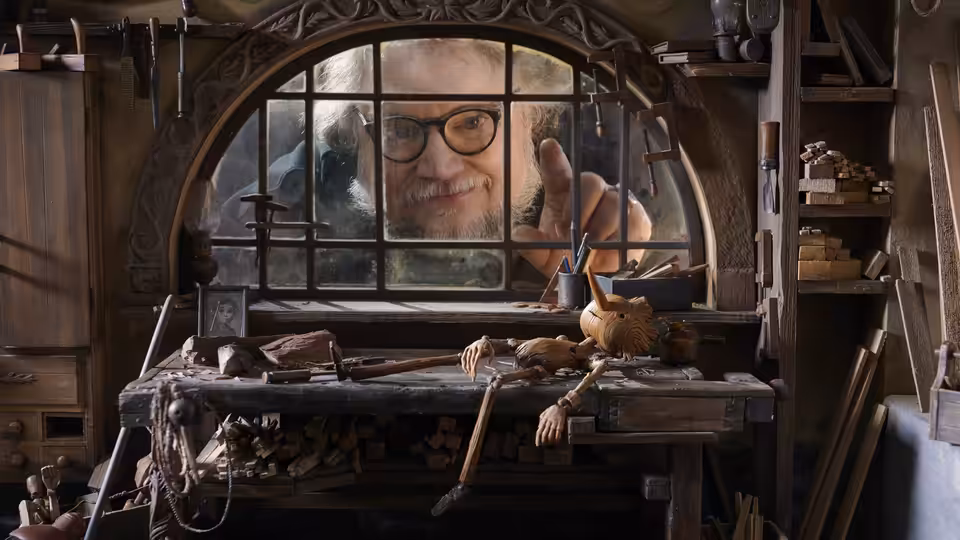Geppetto (David Bradley) peering through the window of his wooden workshop