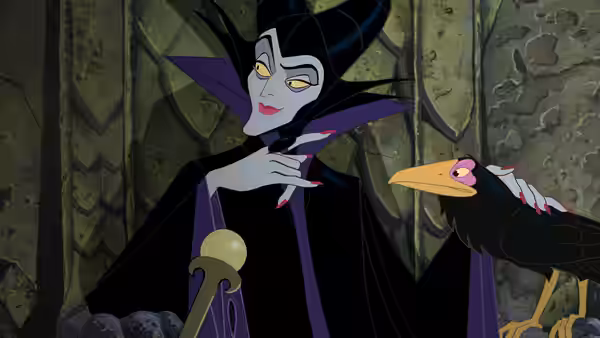 Maleficent stands in a dark hall with her raven perched nearby