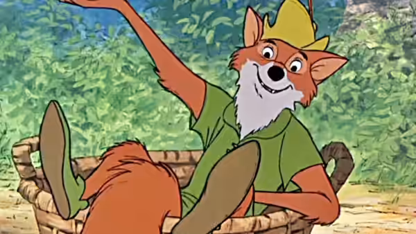 Robin Hood (Brian Bedford) waves from inside a wooden cart