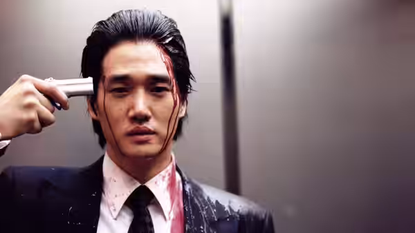 Man pressing a pistol against his bloodied temple inside an elevator