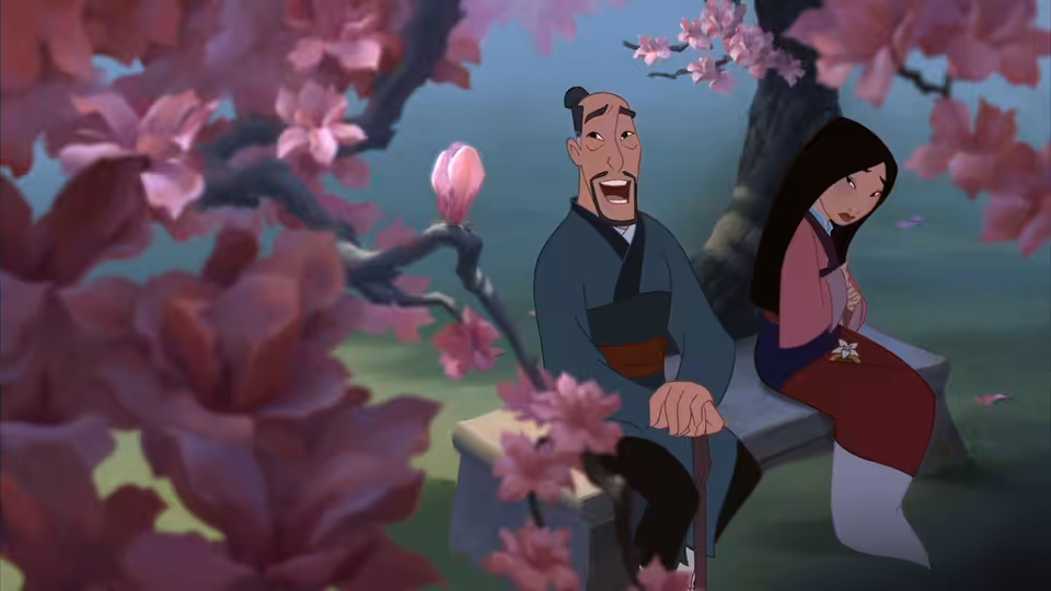 Older man with staff speaking to young woman on bench beneath pink blossoms