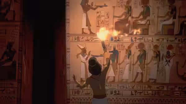 Man lifting a torch to examine temple wall carvings