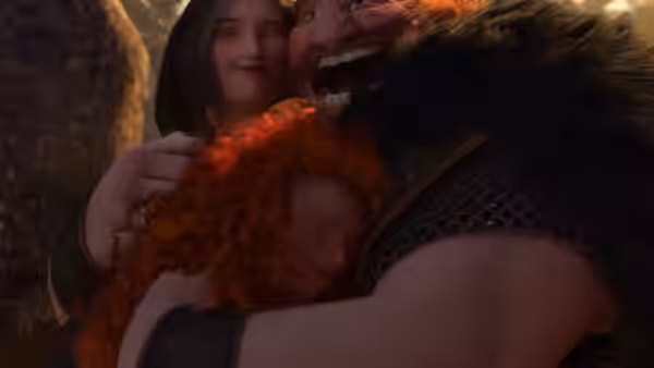 Fergus embraces Merida while Elinor stands close behind them