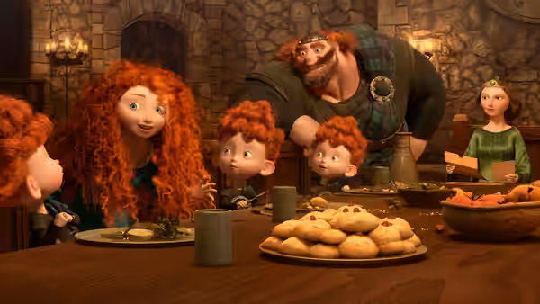Merida sits with her triplet brothers at the feast as Fergus leans over the table