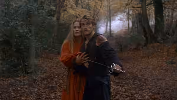 Buttercup (Robin Wright) clings to Westley (Cary Elwes) holding a sword in the woods