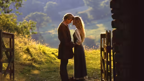 Westley (Cary Elwes) and Buttercup (Robin Wright) stand close together by a wooden gate