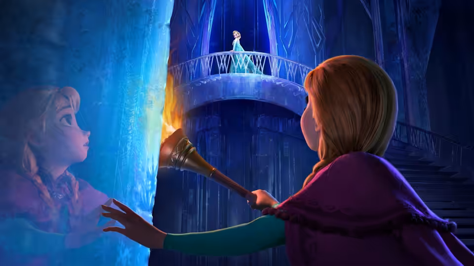 Anna (Kristen Bell) holds a torch and looks up at Elsa (Idina Menzel) on the balcony