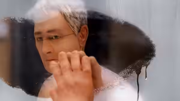 Michael Stone (David Thewlis) with hand against a frosted mirror