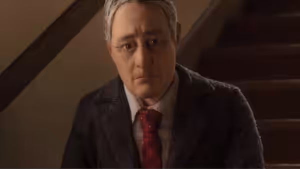 Michael Stone (David Thewlis) in a suit and red tie looking down