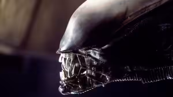 The alien's head in profile showing teeth and biomechanical details