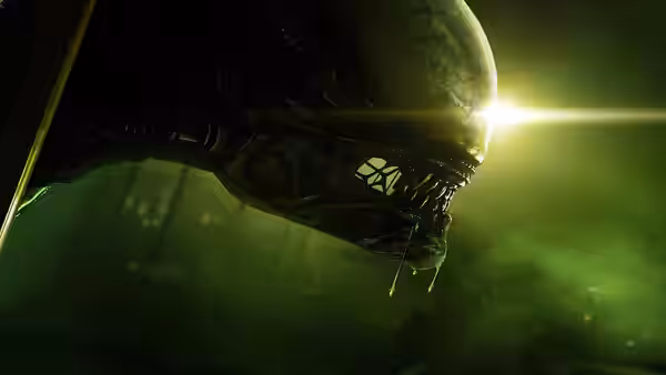 The alien creature with open mouth dripping saliva in green light