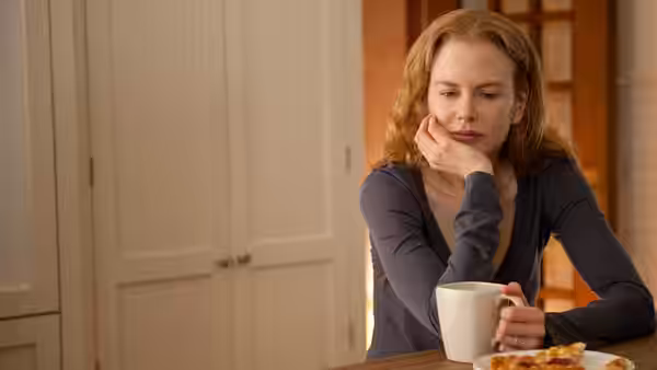 Becca (Nicole Kidman) resting her head on her hand at a table