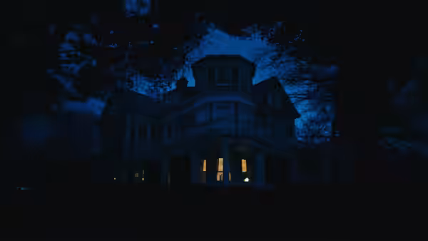 A large house with lit windows at night