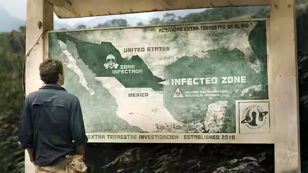 Andrew (Scoot McNairy) standing before a large map of the infected zone