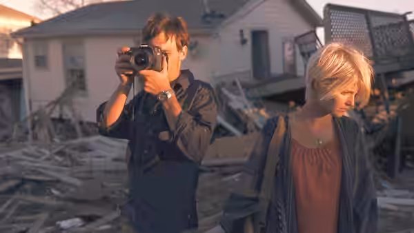 Andrew (Scoot McNairy) photographing with Samantha (Whitney Able) in a ruined neighborhood