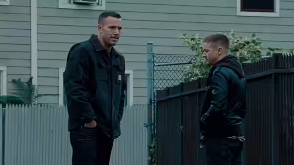 Doug MacRay and Jem Coughlin standing face to face in a backyard