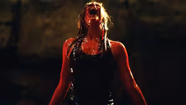 Woman covered in blood screams with head tilted back