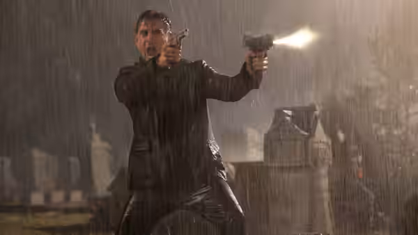 Marty (Colin Farrell) firing two guns in the rain at night