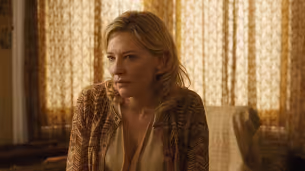 Jasmine (Cate Blanchett) seated indoors with a concerned expression