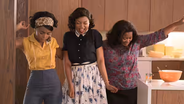 Mary Jackson (Janelle Monáe), Katherine G. Johnson (Taraji P. Henson) and Dorothy Vaughan (Octavia Spencer) dancing in a kitchen