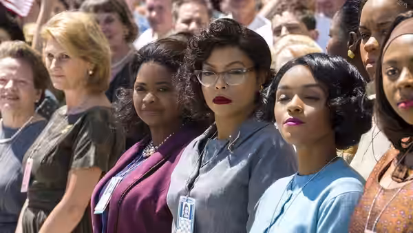 Katherine G. Johnson (Taraji P. Henson) and colleagues standing in a crowd of spectators