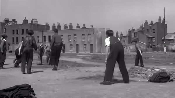 Men stand among bodies scattered across an open city street