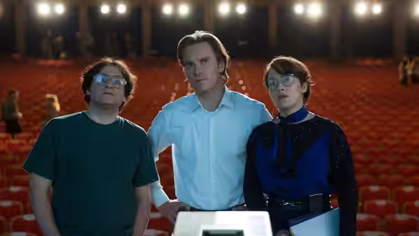Steve Wozniak (Seth Rogen) Steve Jobs (Michael Fassbender) and Joanna Hoffman (Kate Winslet) stand in an auditorium